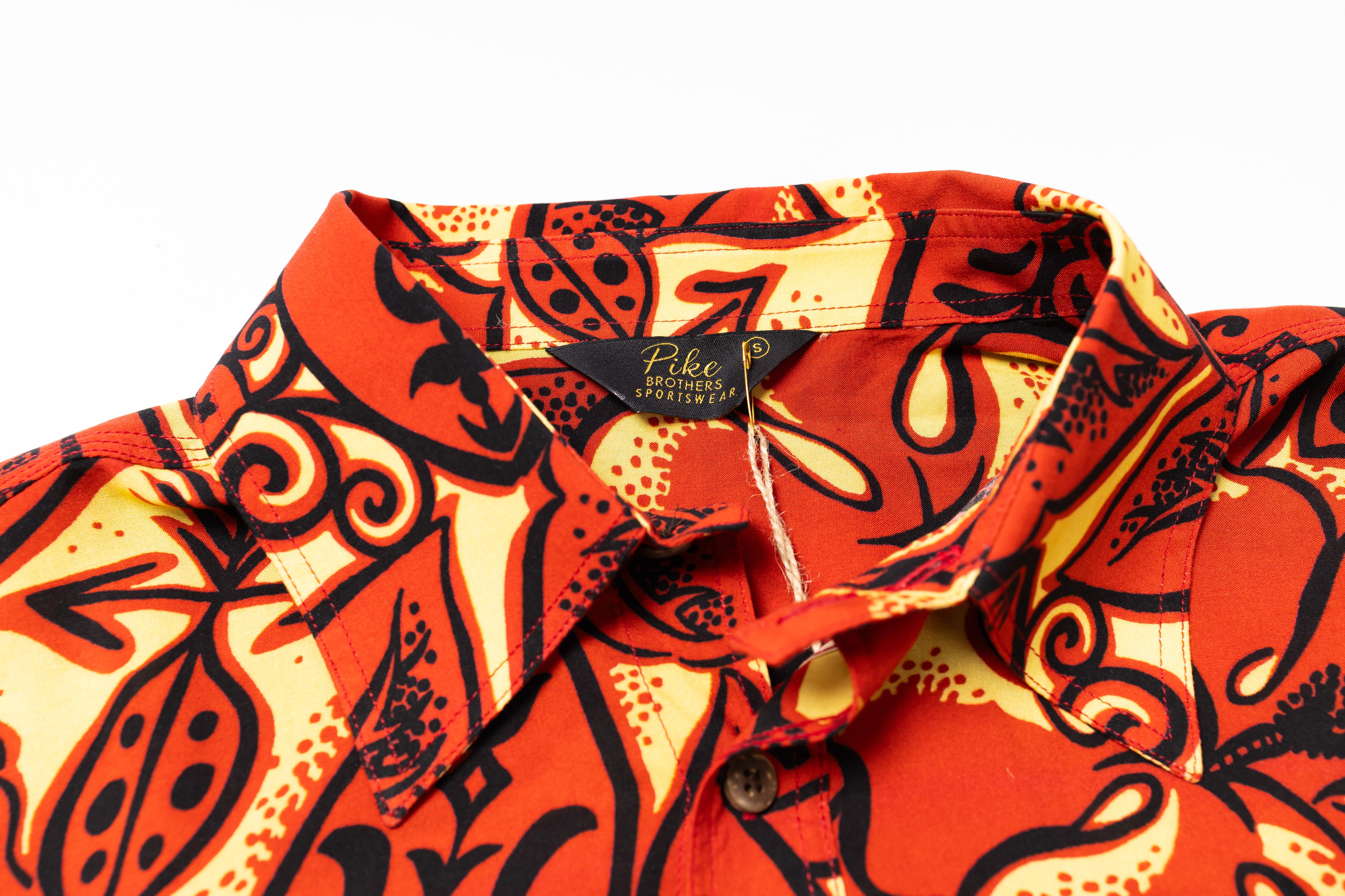 Orange and black patterned shirt with a brand label on a white background