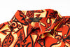 Orange and black patterned shirt with a brand label on a white background
