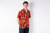 Man wearing a red and yellow patterned shirt on a white background