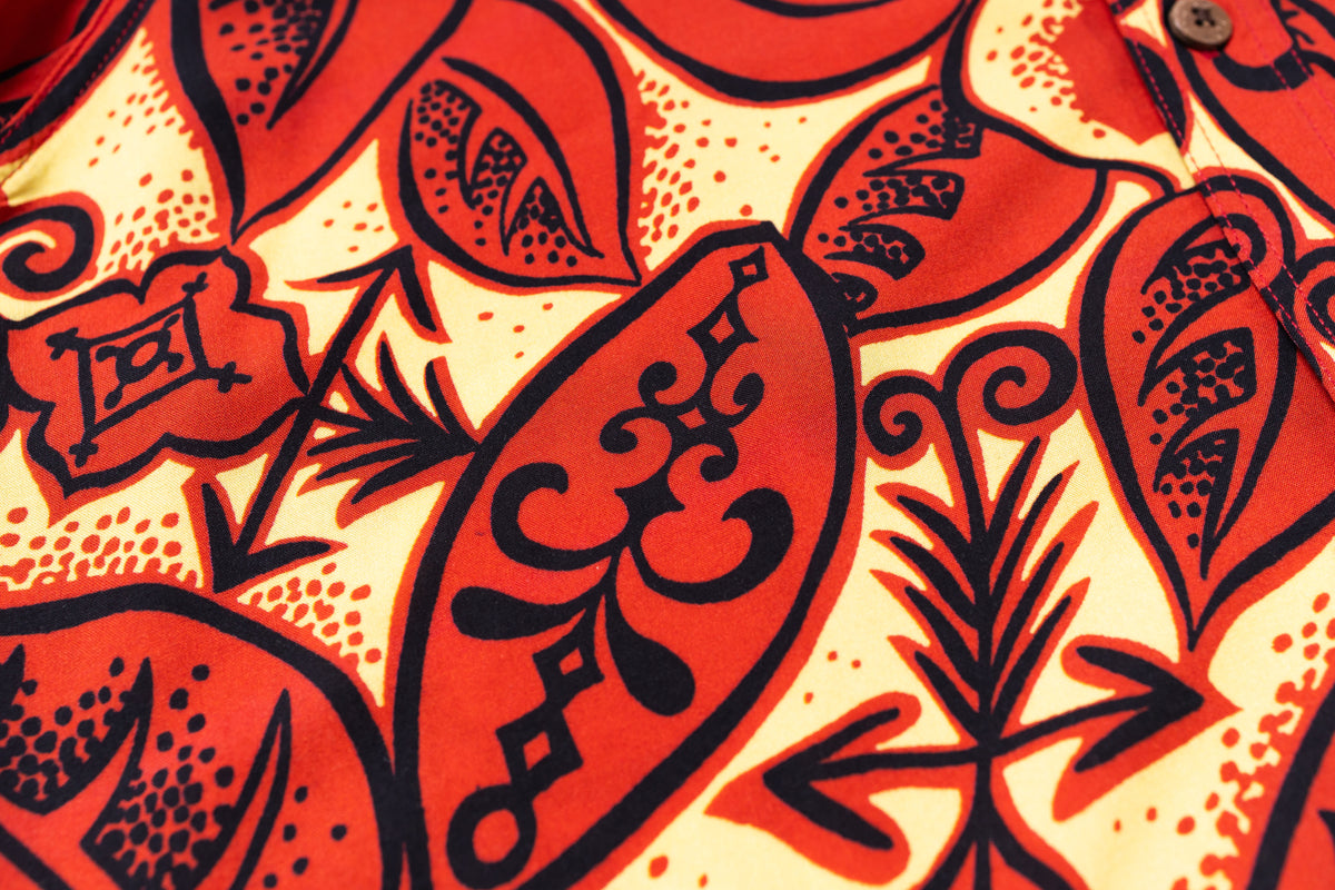 Close-up of a red and black floral pattern on a textured fabric background