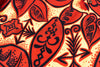 Close-up of a red and black floral pattern on a textured fabric background