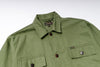 Green shirt with collar and button details on a white background