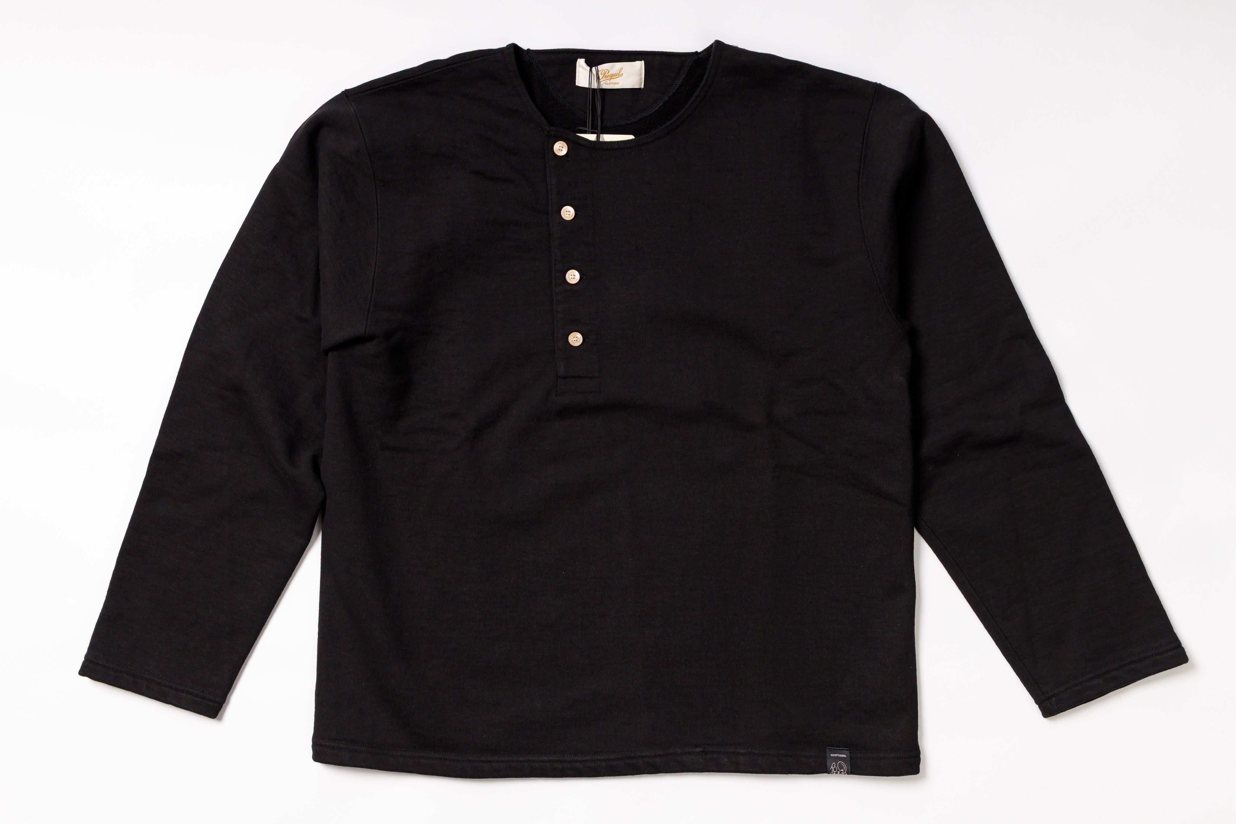 Black long-sleeve shirt with button details on a white background