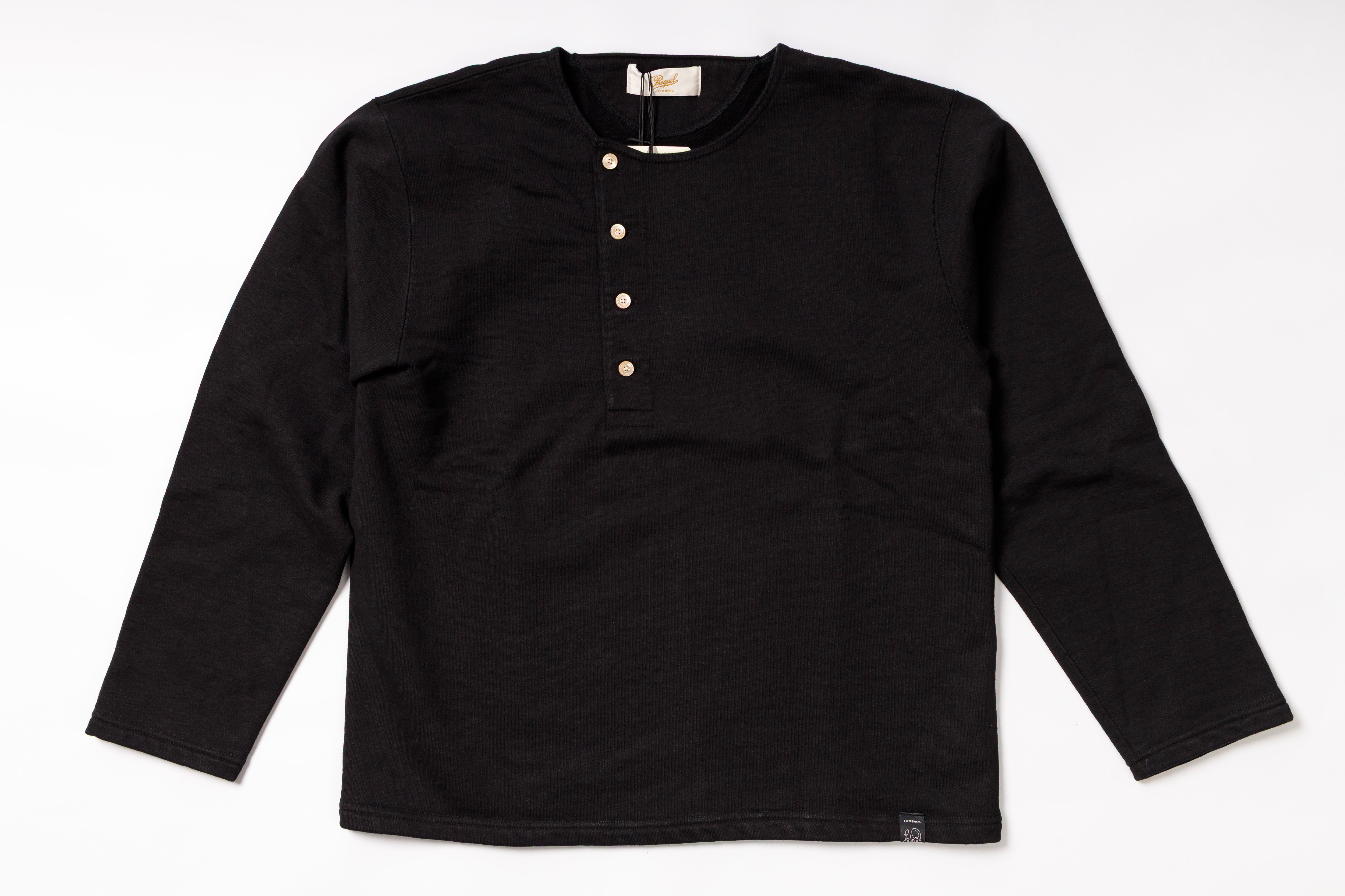 Black long-sleeve shirt with button details on a white background