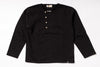 Black long-sleeve shirt with button details on a white background