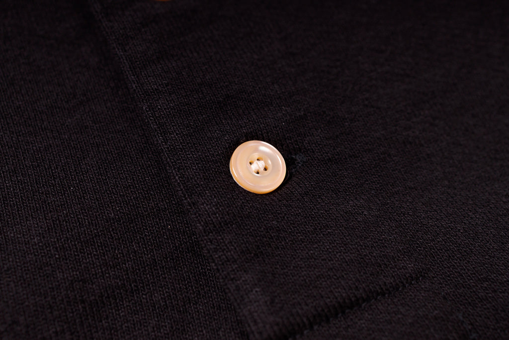 Close-up of a button on a black fabric background