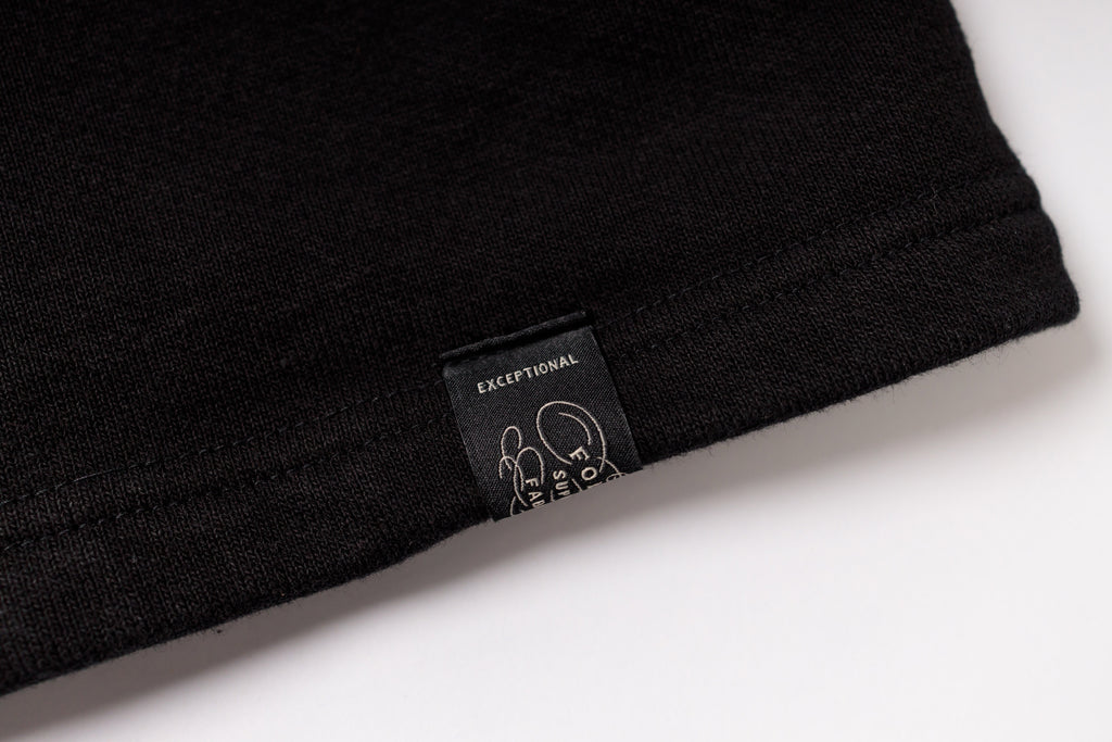 Black t-shirt with a label on a white background