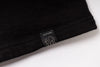 Black t-shirt with a label on a white background