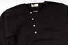 Black henley shirt with buttons on a white background