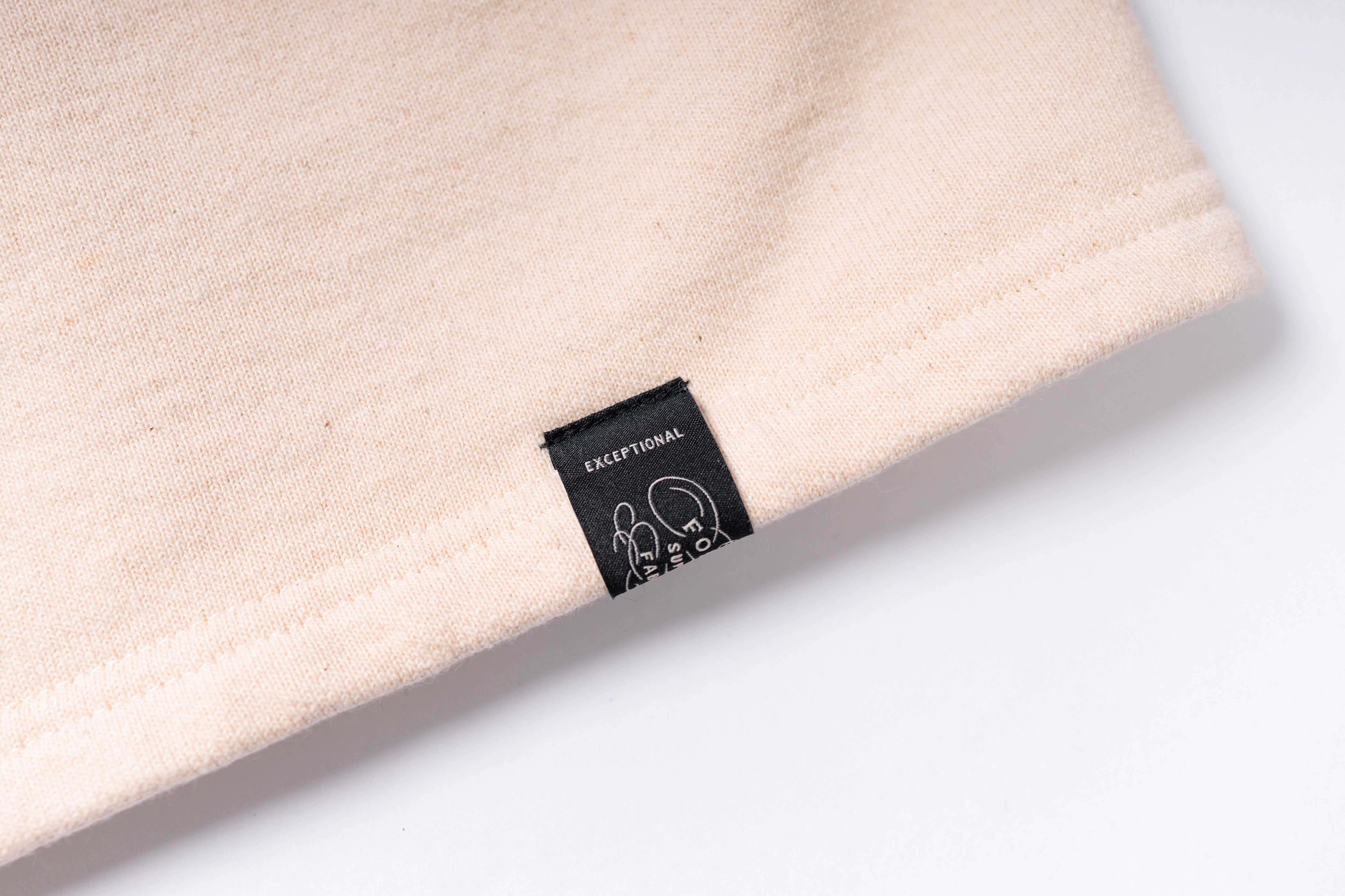 Close-up of a beige fabric with a label on a white background