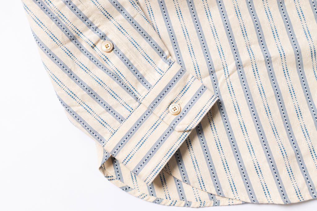 Close-up of a striped shirt with a focus on the collar and buttons.