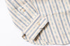 Close-up of a striped shirt with a focus on the collar and buttons.