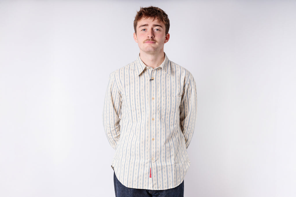 Man wearing a striped shirt against a plain background