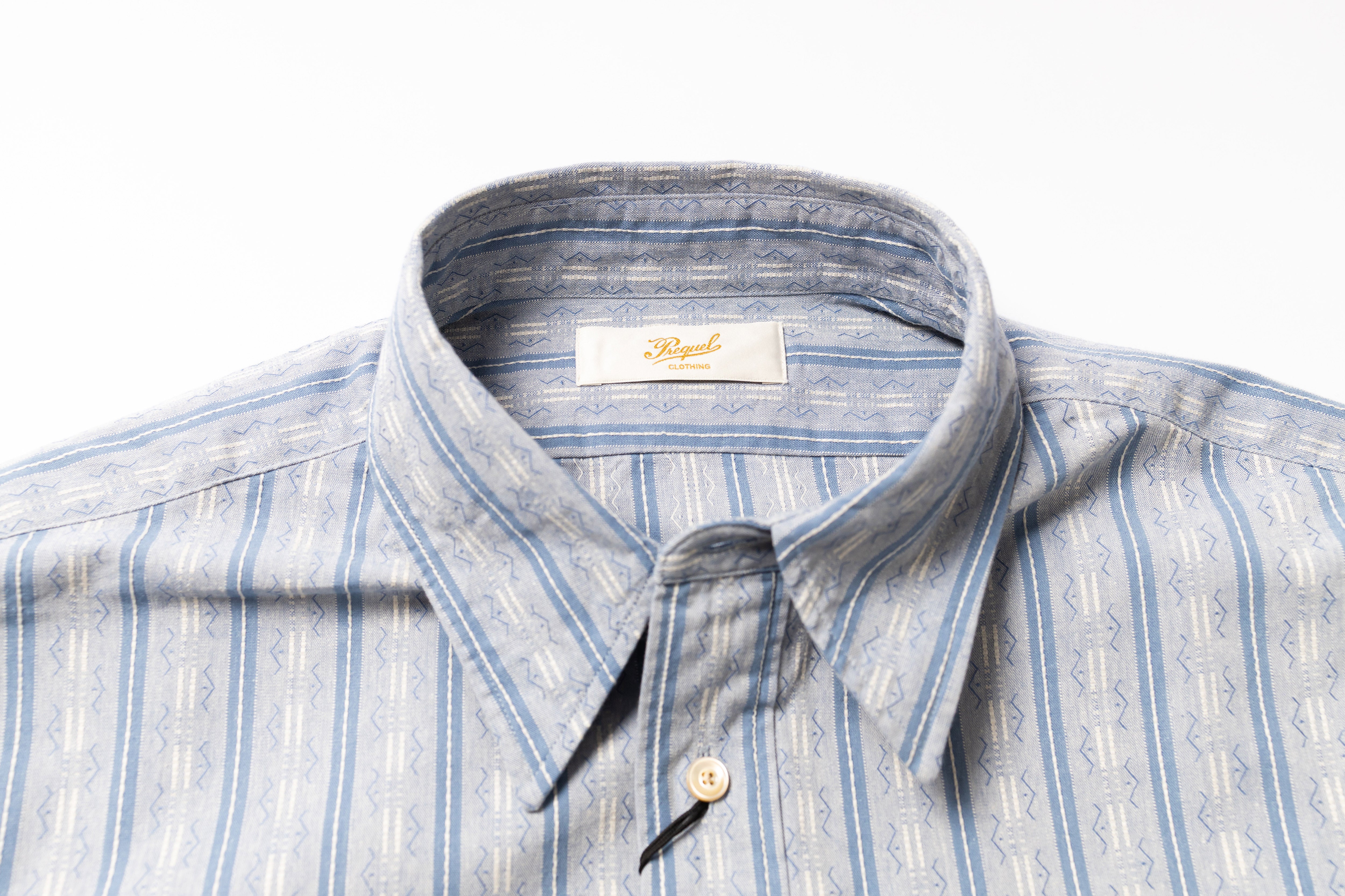 Blue and white striped shirt with collar detail on a white background