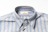 Blue and white striped shirt with collar detail on a white background