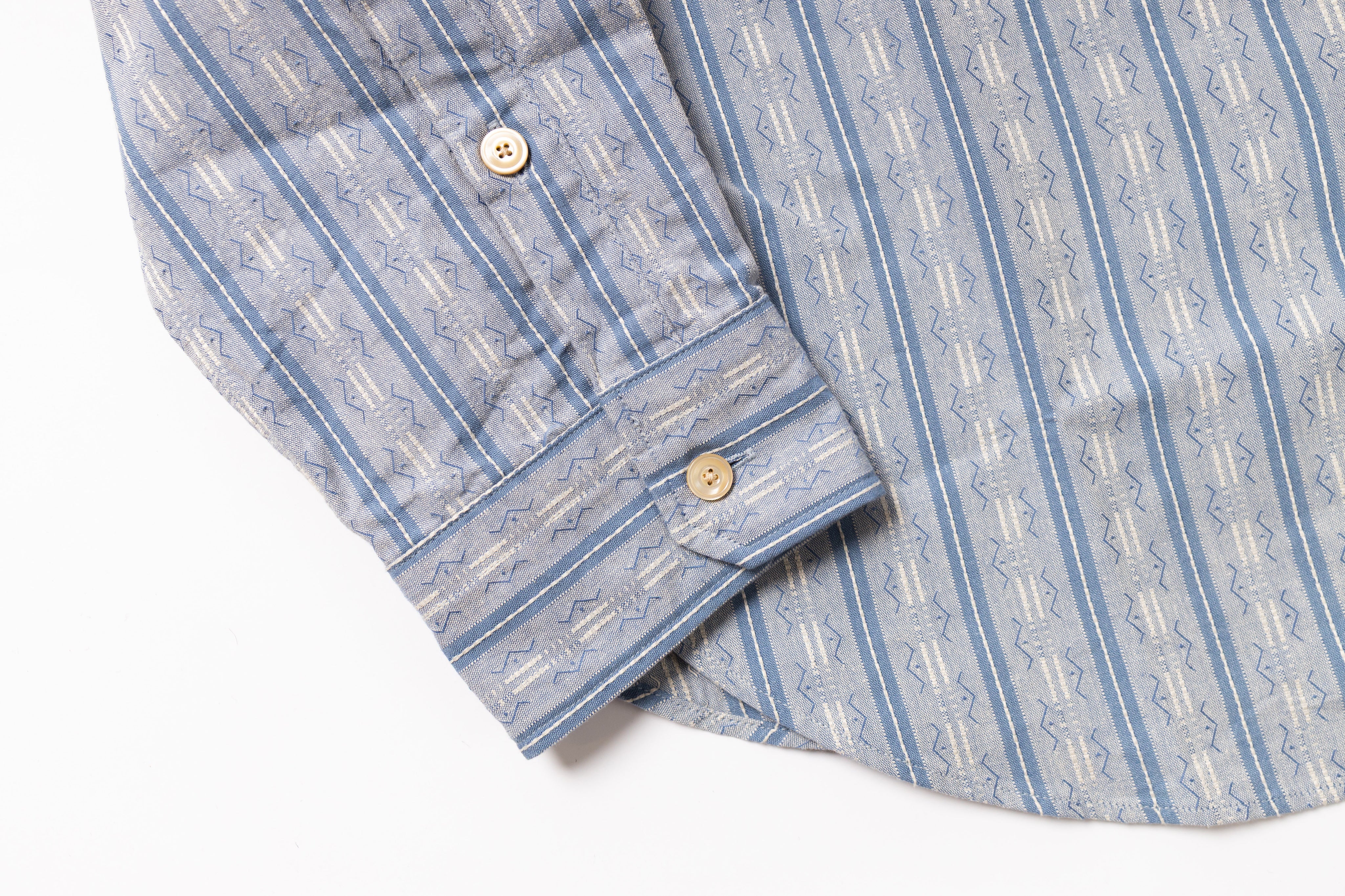 Folded blue and white striped shirt on a white background