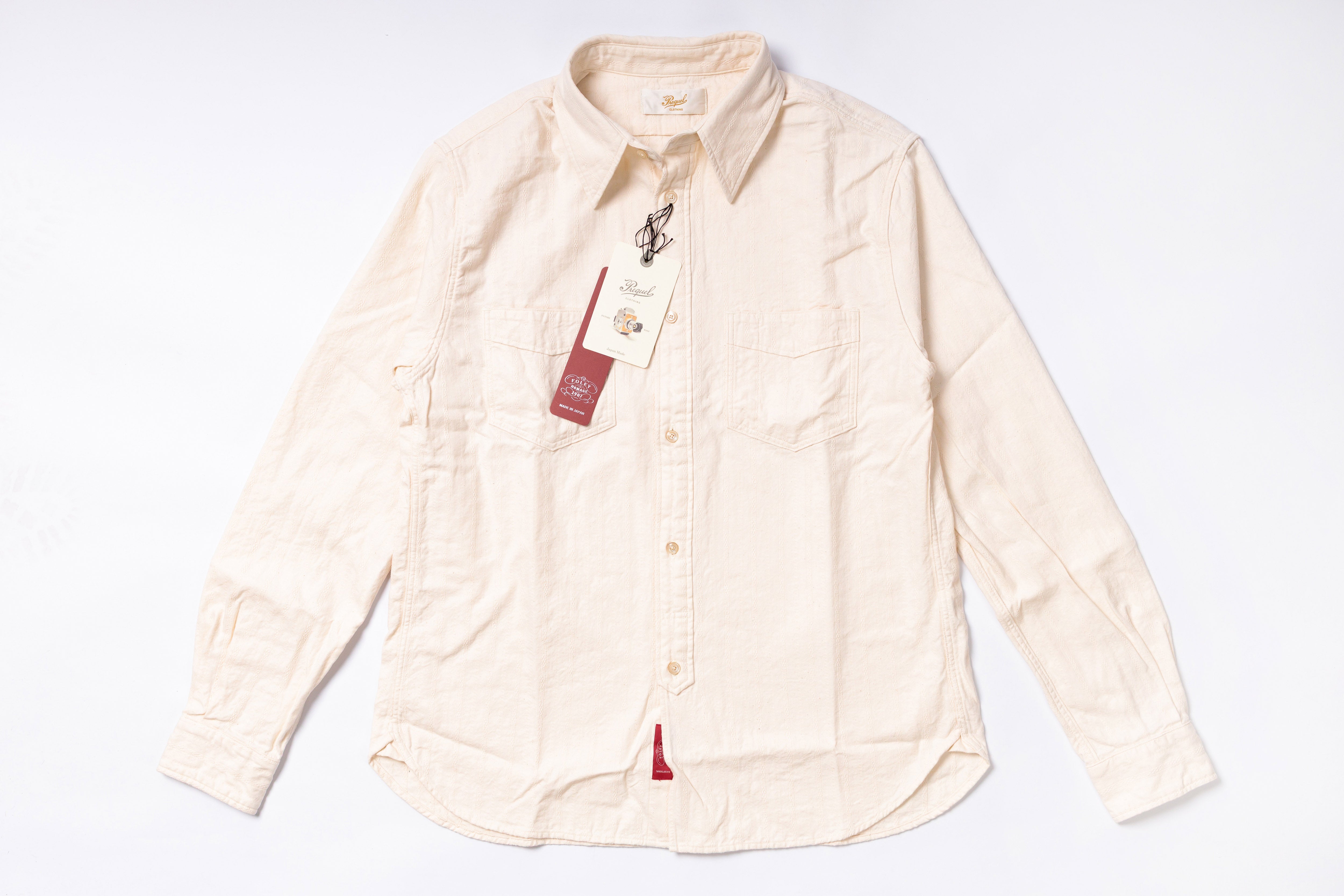 Beige shirt with a tag on a white background
