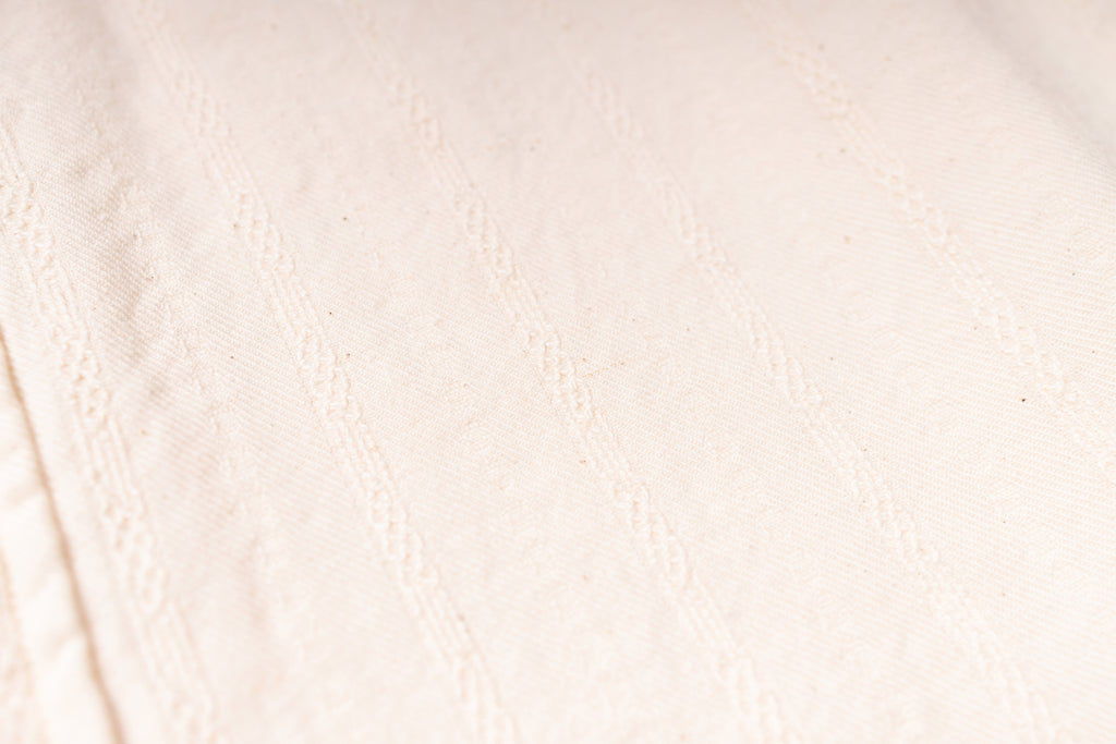 Close-up of a textured beige fabric surface
