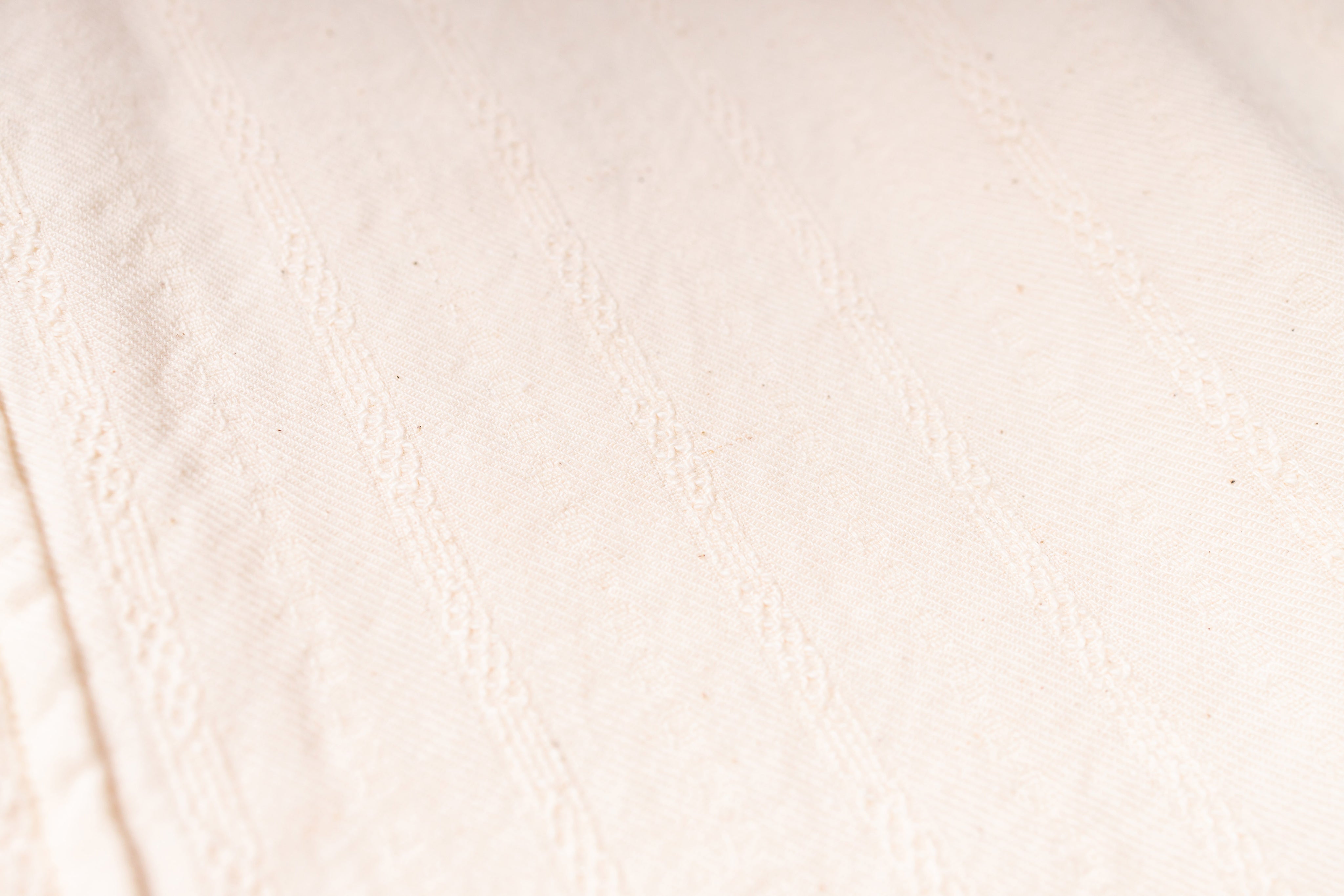 Close-up of a textured beige fabric surface