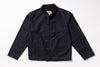 A dark navy blue canvas utility jacket with a button-up front, laid flat against a white background.
