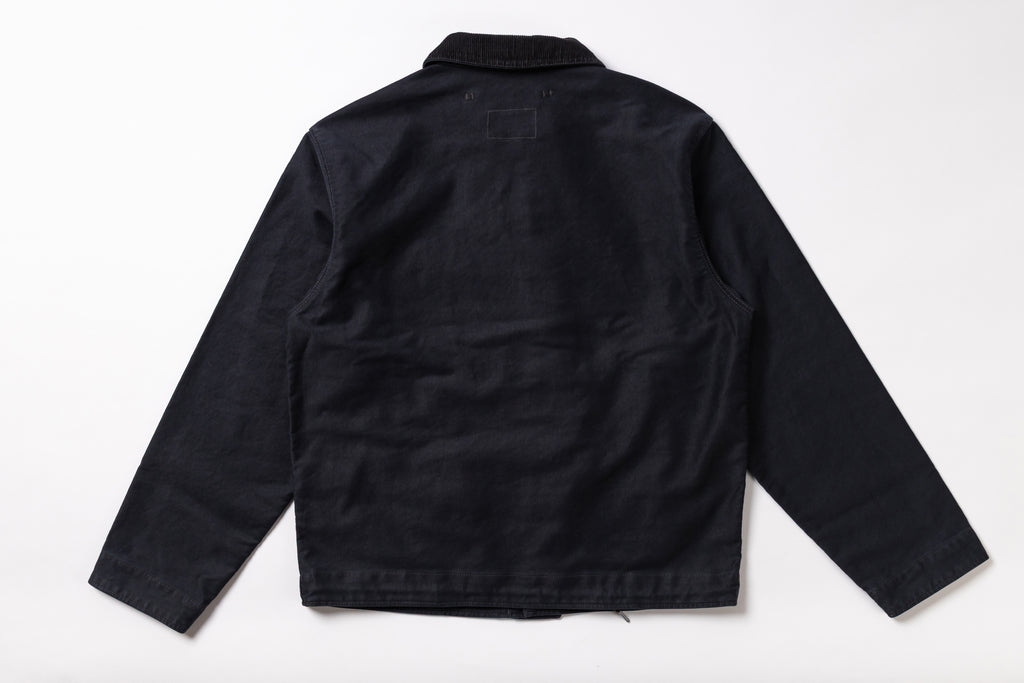 A black long-sleeve utility jacket shown from the back, laid flat against a clean white background.