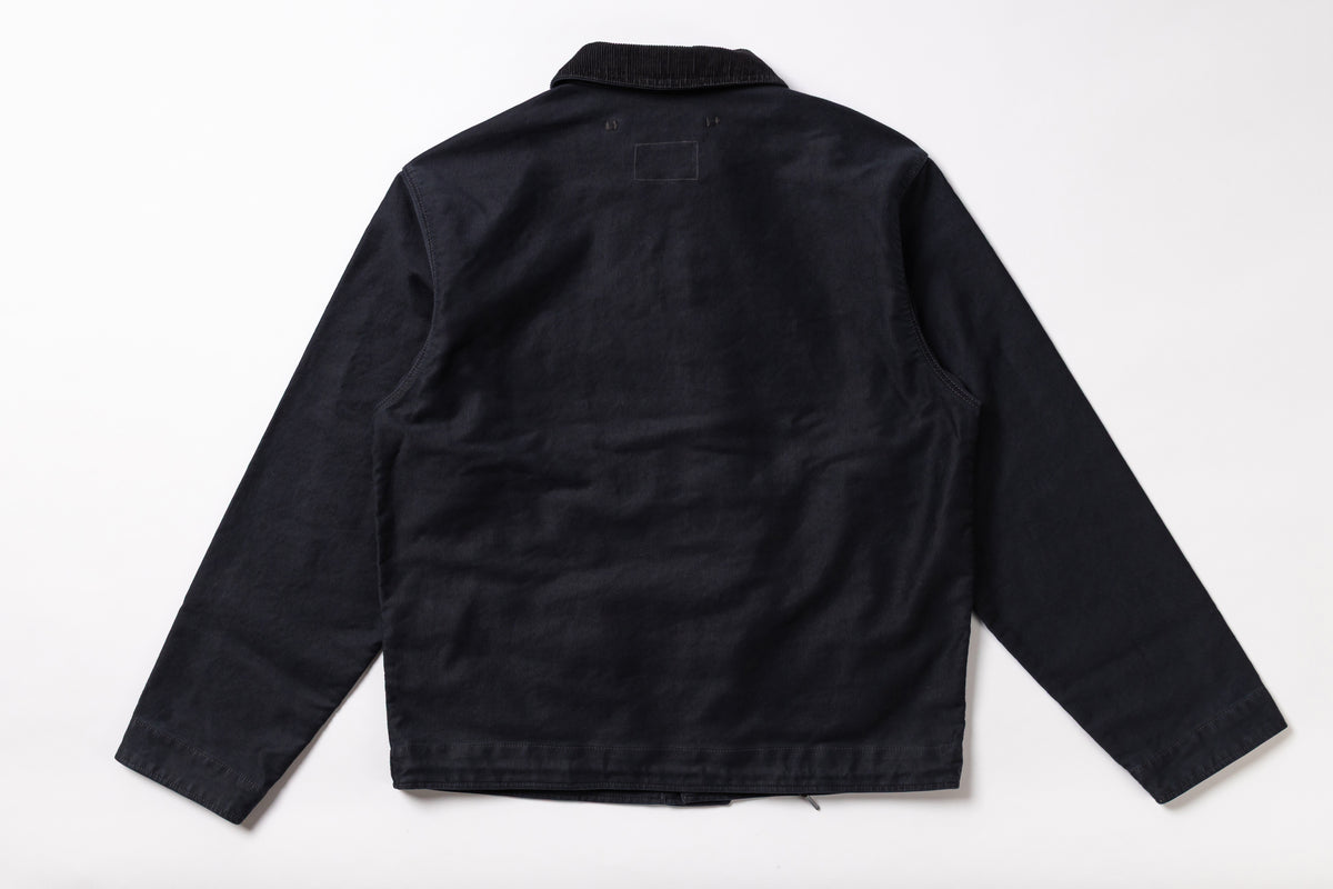 A black long-sleeve utility jacket shown from the back, laid flat against a clean white background.