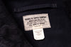 Close-up of a dark navy garment interior showing a sewn paper label that reads 'DOUBLE RL SUPPLY COMPANY' and a smaller 'Made in India' tag below it.