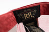 Close-up of the interior label of a red cap, showing a black Ralph Lauren patch with gold embroidery reading 'Est. 1993 Double RL' and 'Ralph Lauren', alongside a white mesh fabric and inner tag.