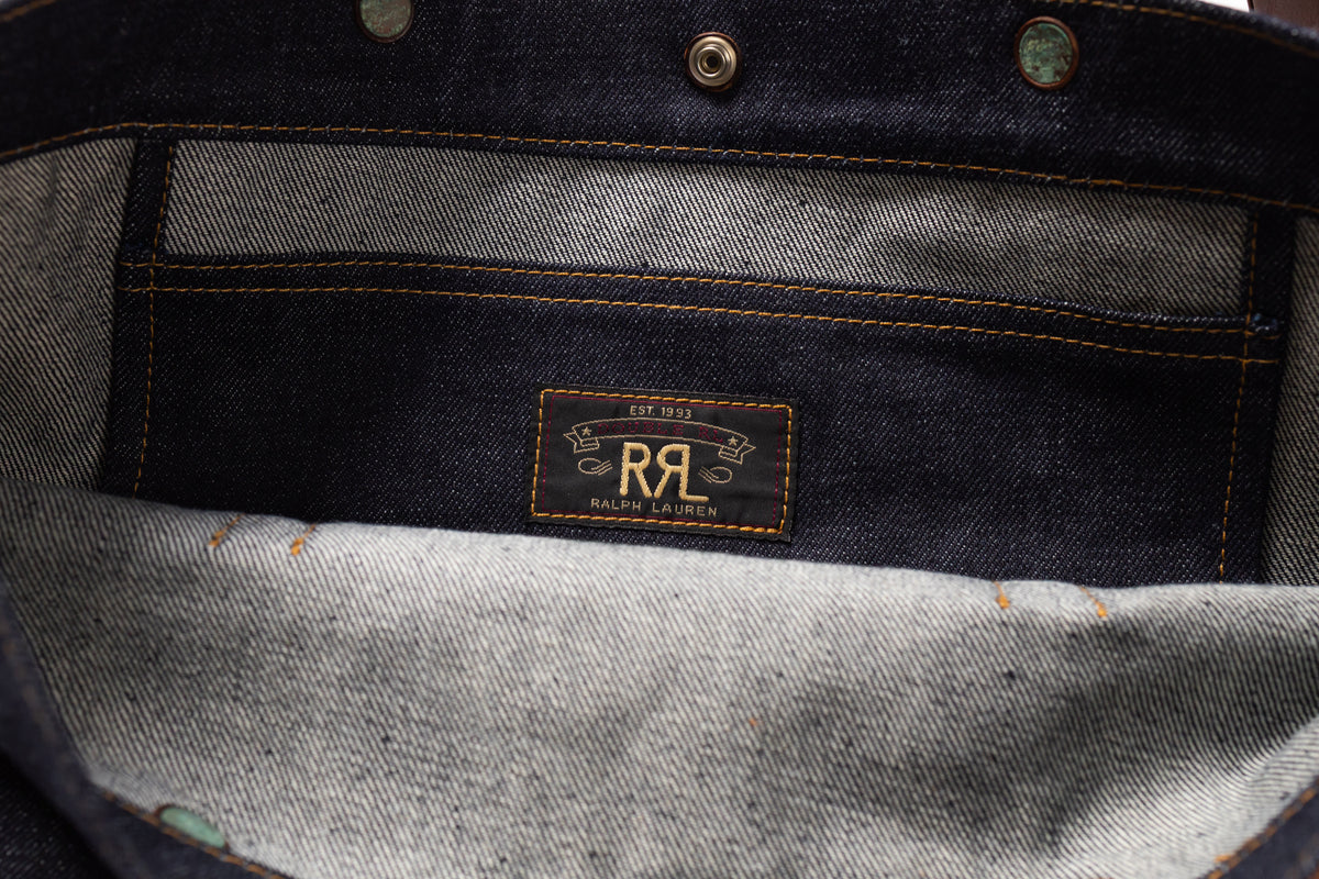 Close-up of the interior of a dark indigo denim garment, showing a central patch.
