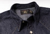 Close-up of a dark indigo denim button-down shirt collar with a visible neck label reading RRL Design.