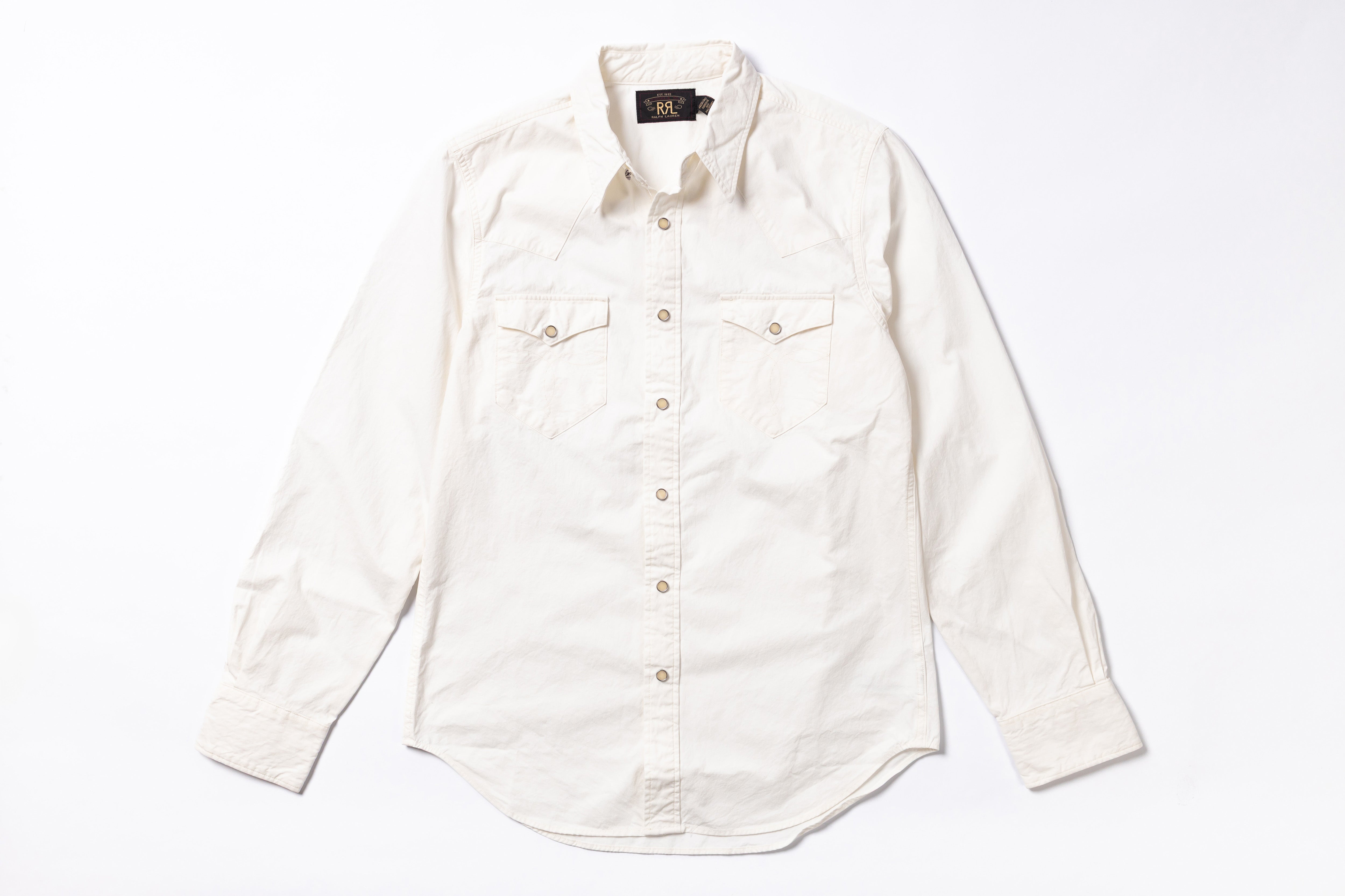 An off-white long-sleeve button-down shirt with two buttoned chest pockets, laid flat on a white background.