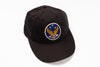 A black cotton baseball cap featuring a circular embroidered patch on the front with a blue background, gold wings, white stars, and the letters 'RPL' in red.