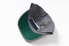 A folded gray baseball cap with a green visor and a dark blue adjustable strap, photographed on a clean white background.