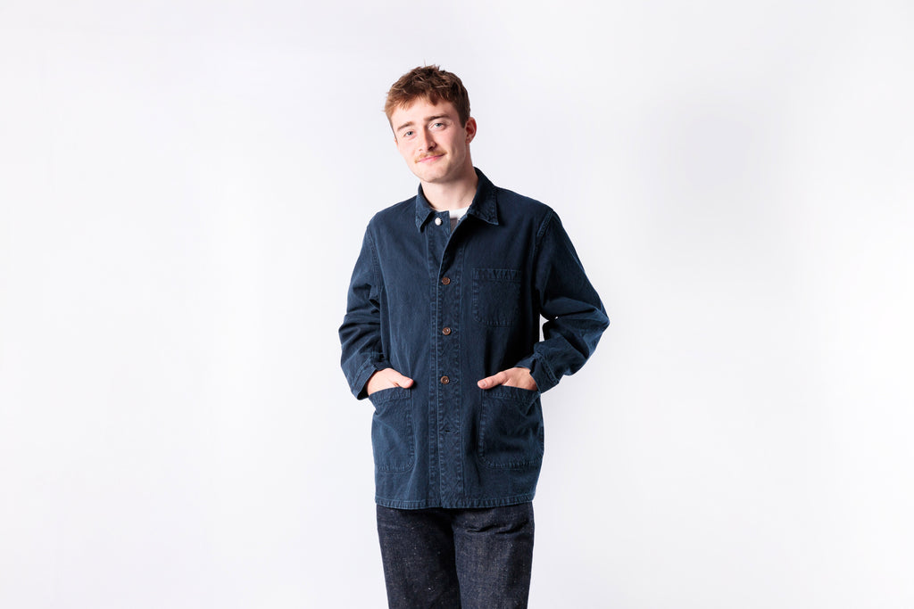 Man wearing a dark blue jacket on a white background