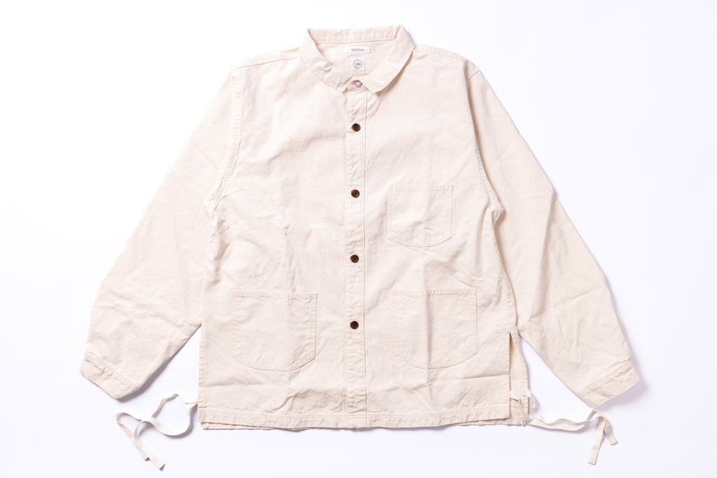 Beige jacket with button details on a white background