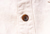 Close-up of a button on a light-colored fabric