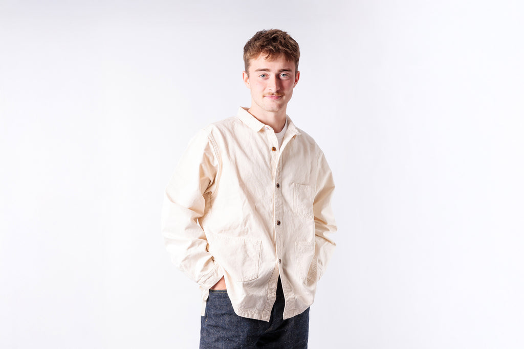 Man wearing a beige shirt on a white background