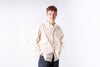 Man wearing a beige shirt on a white background