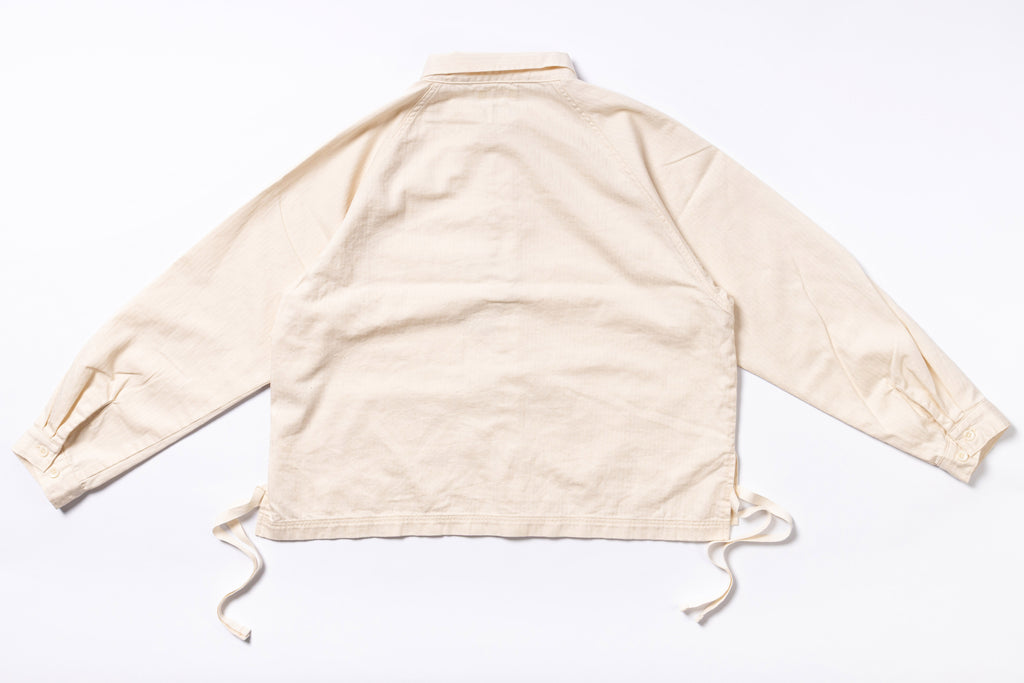 Beige long-sleeve shirt with drawstrings on a white background