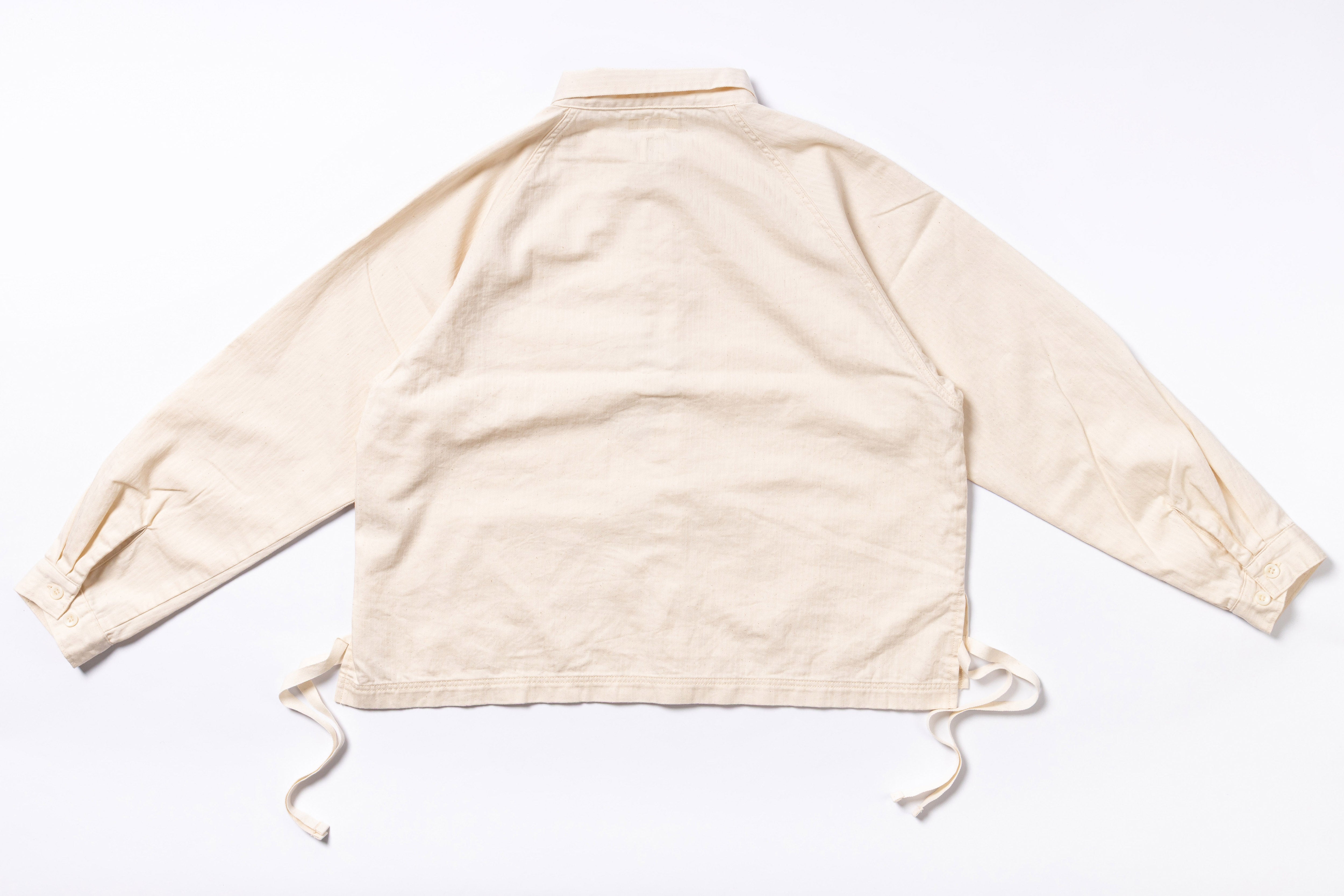 Beige long-sleeve shirt with drawstrings on a white background