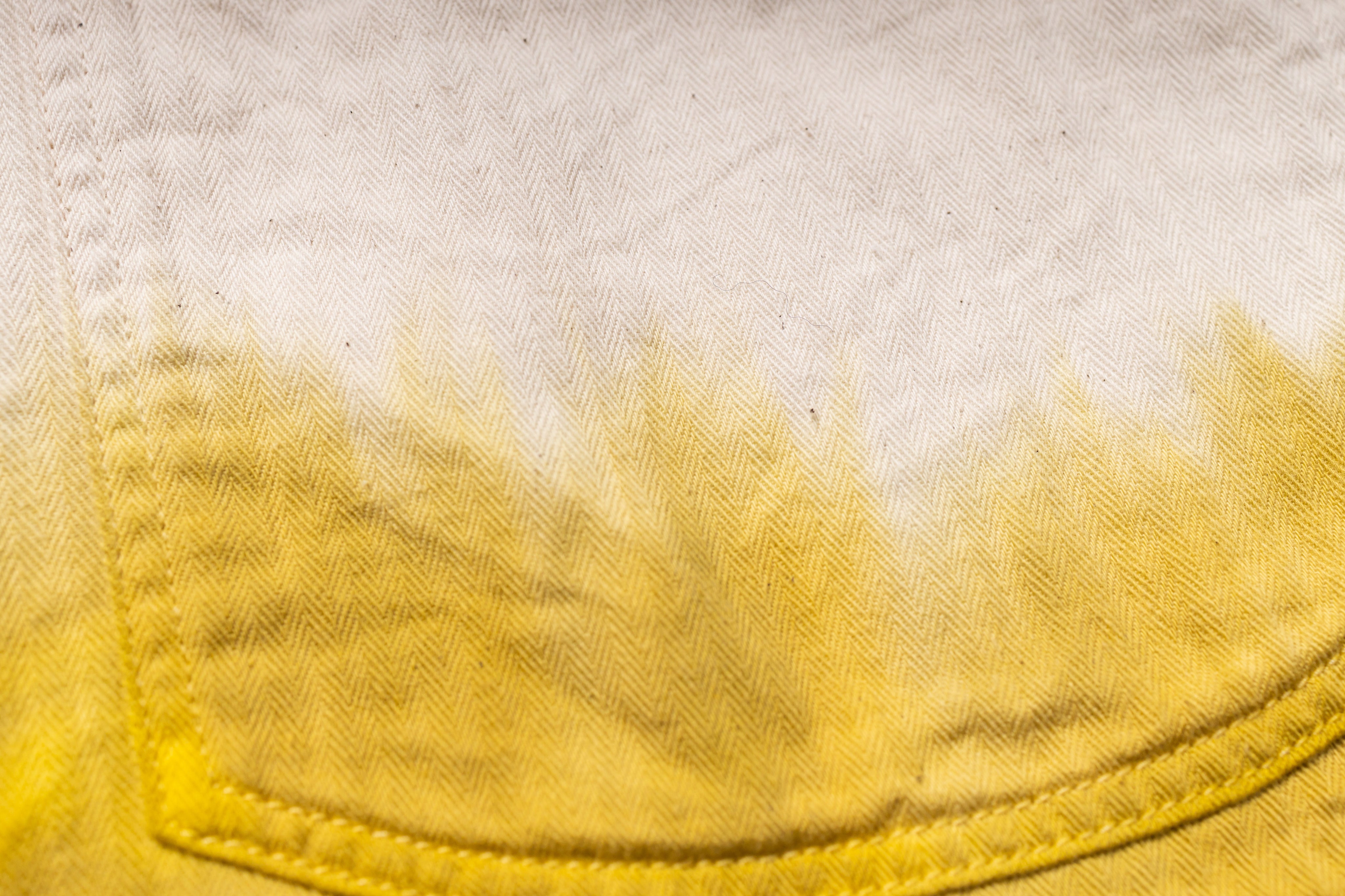 Close-up of a yellow pocket on a light fabric background