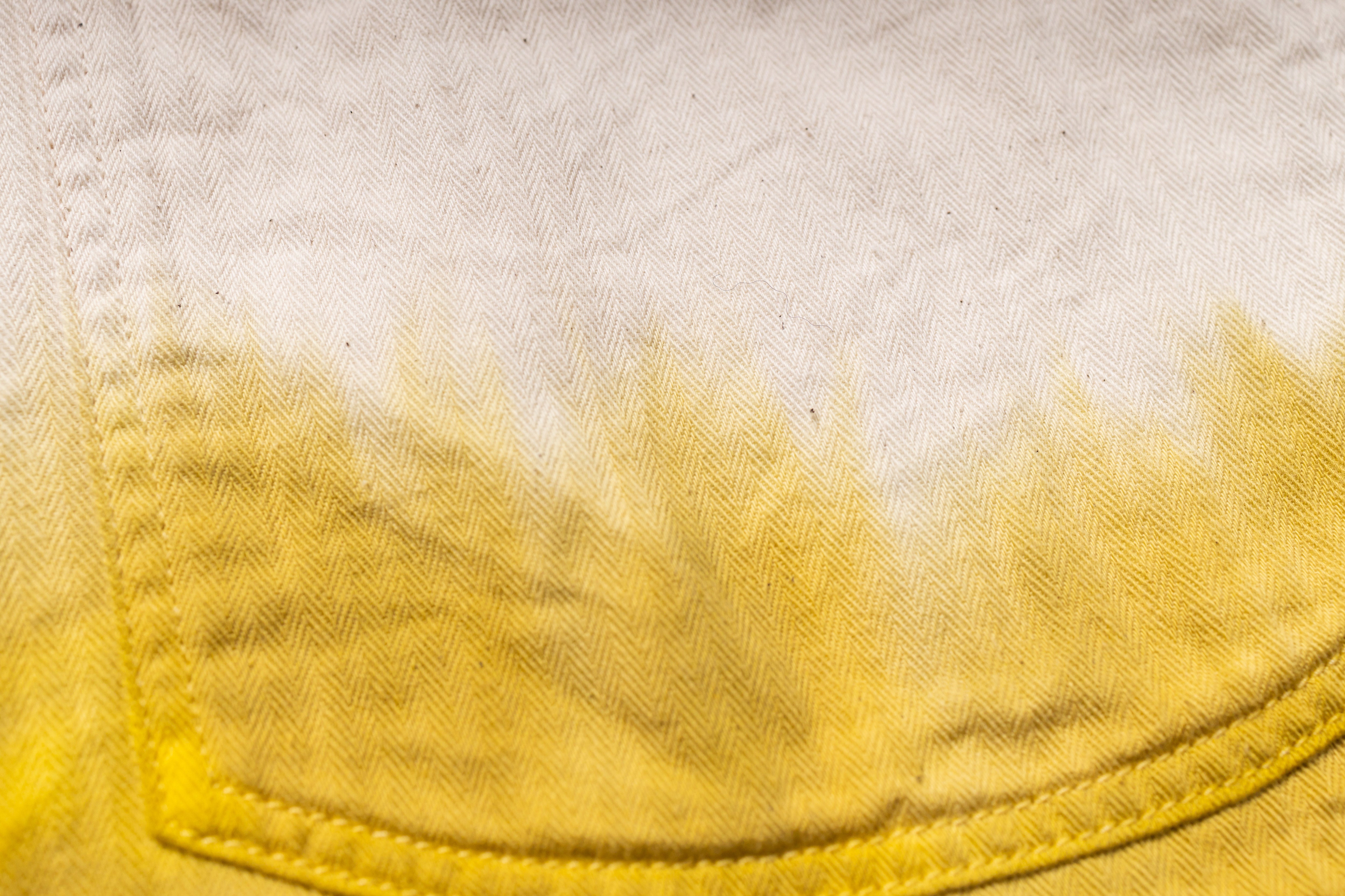 Close-up of a yellow pocket on a light fabric background
