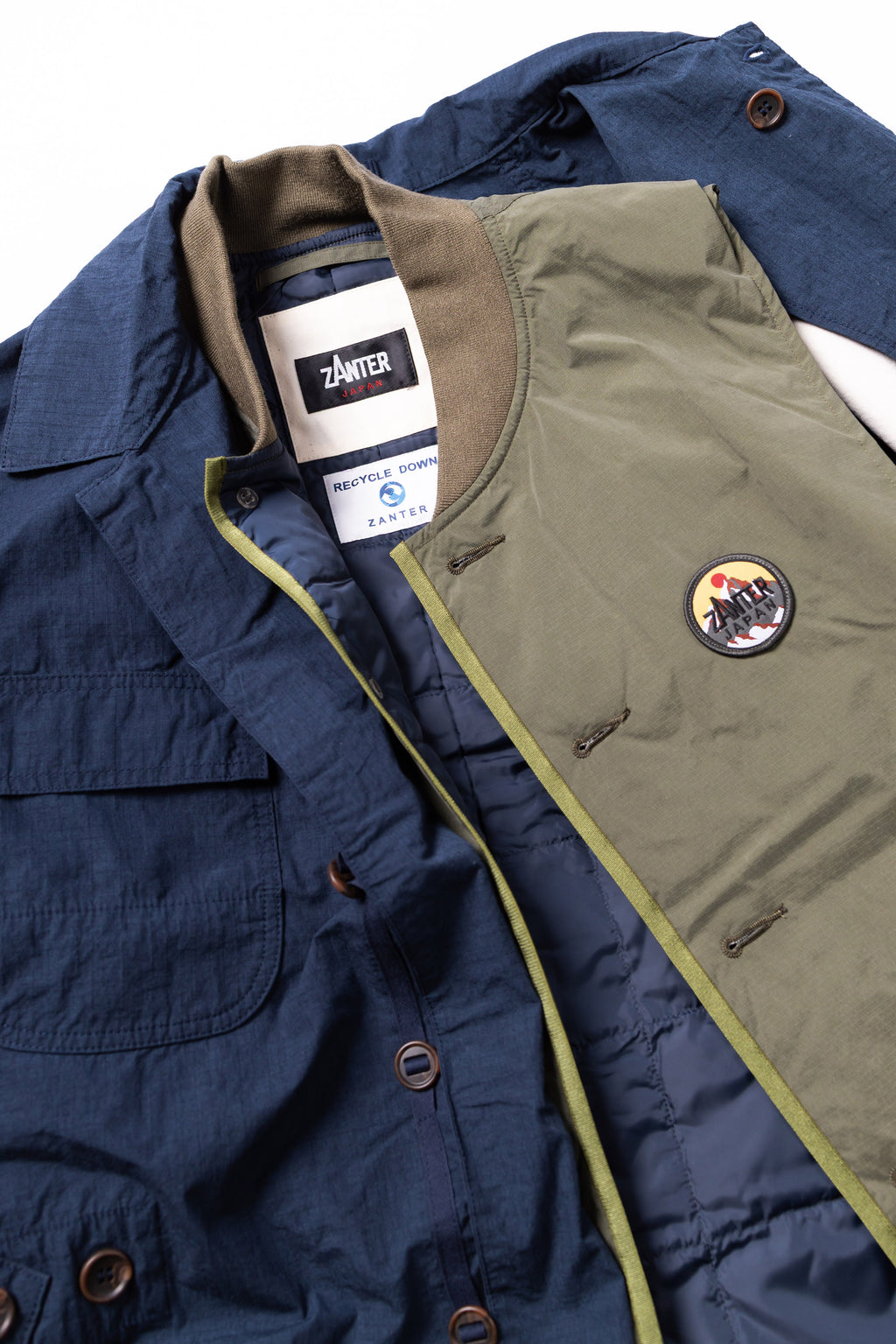 Navy jacket with green lining and a patch, featuring a brand tag.
