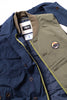 Navy jacket with green lining and a patch, featuring a brand tag.