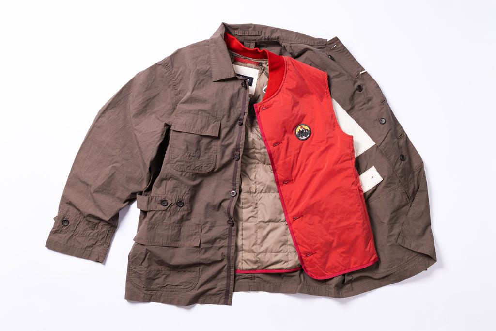 Brown jacket with a red inner lining and a logo on a white background