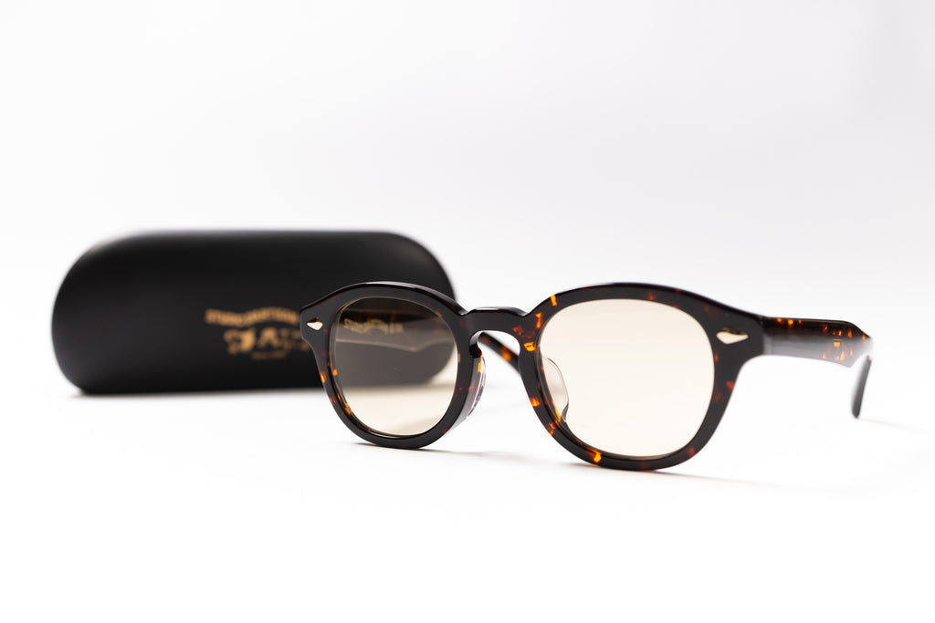 Tortoiseshell eyeglasses with a black case on a white background