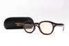 Tortoiseshell eyeglasses with a black case on a white background