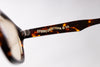 Tortoiseshell sunglasses with 'Studio D'artisan branding on a light gray background