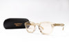 Beige eyeglasses with a black case on a white background
