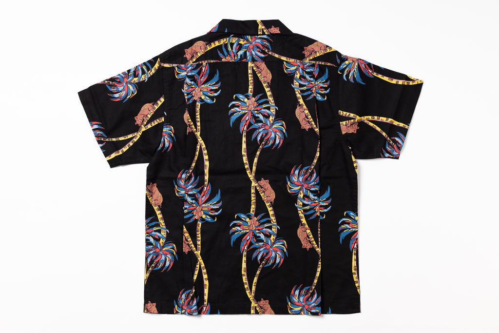 Black shirt with colorful palm tree pattern on a white background